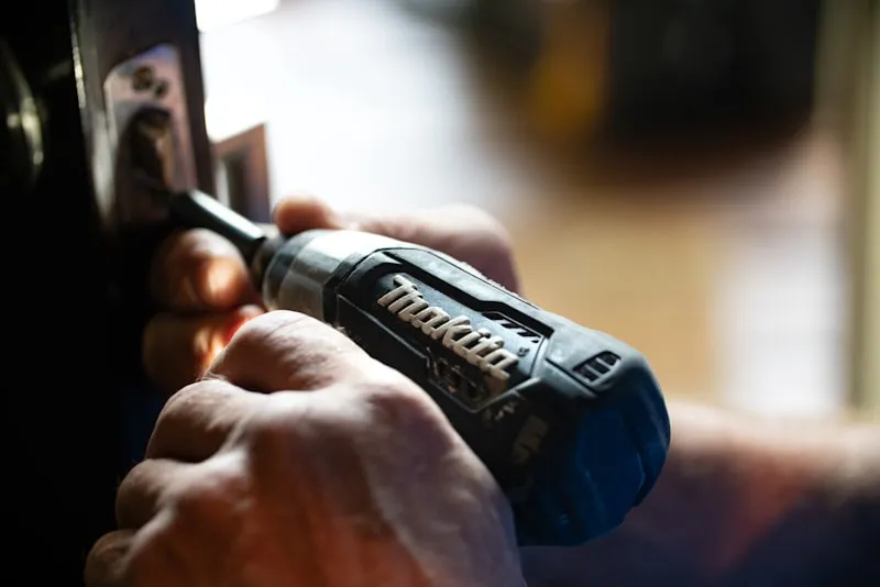 Artisan carpenter using hand tools on bespoke wooden furniture